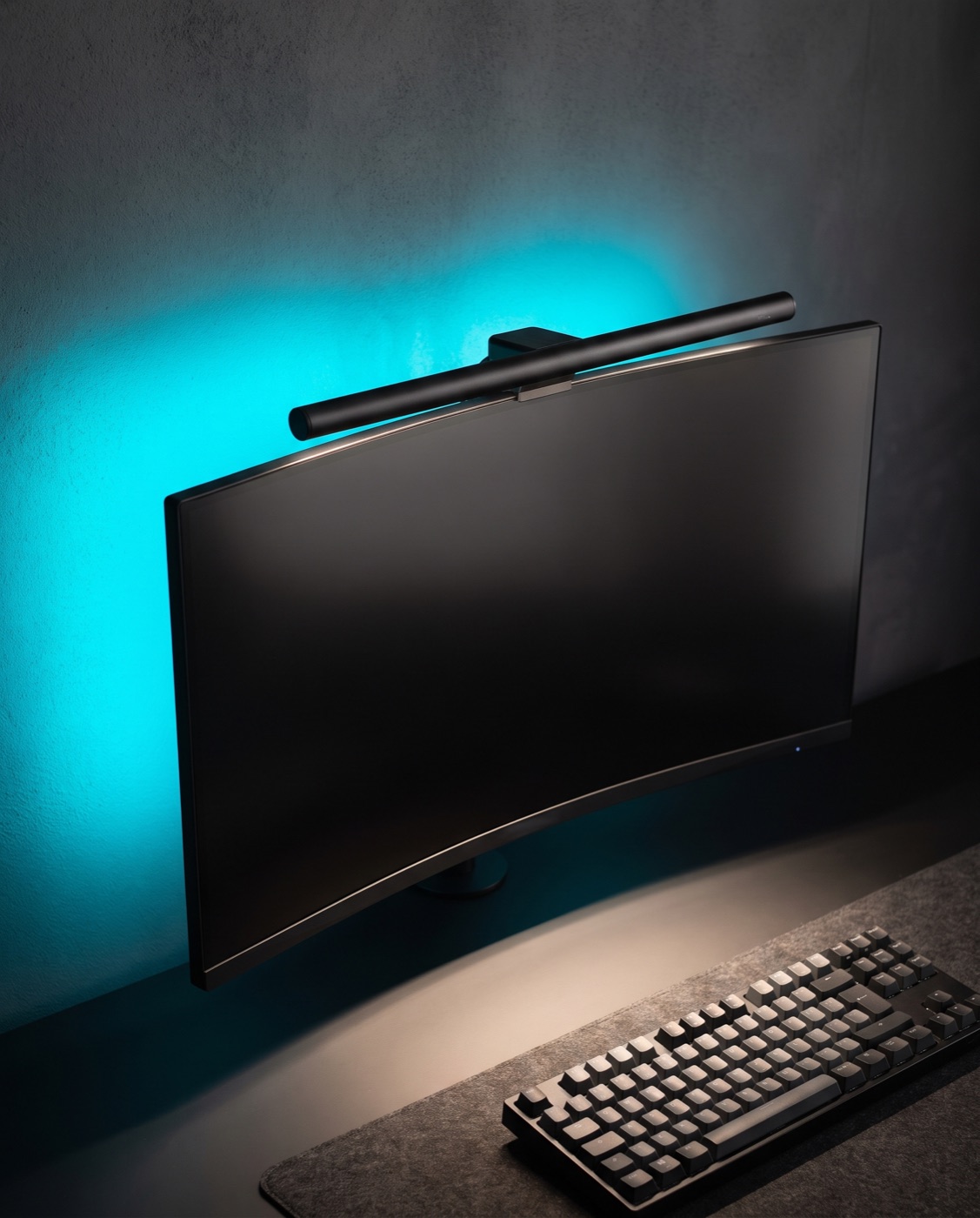 HexGlow Light Bar on a curved monitor, cyan glow on the wall, warm light on the desk